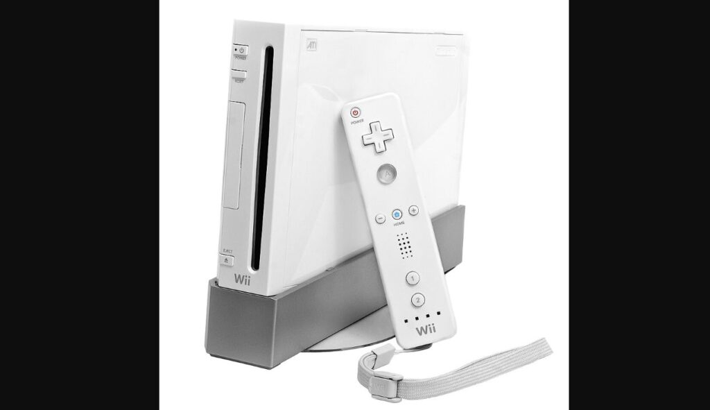 縦置きスタンドに載せた白いWii本体と、ストラップ付きのWiiリモコン